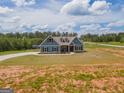 Attractive two-story home with a landscaped front yard and circular driveway at 296 Beavers Rd, Grantville, GA 30220