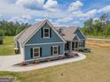 Beautiful two-story home with blue siding, black shutters, and a well-maintained lawn at 296 Beavers Rd, Grantville, GA 30220