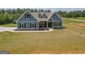 Inviting two-story craftsman home boasting a cozy front porch and manicured landscaping at 296 Beavers Rd, Grantville, GA 30220