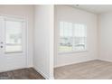 Bright, carpeted room with white door, white trim, and a large window with blinds at 1029 Claas Way, Locust Grove, GA 30248