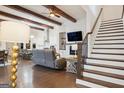 Inviting living room with hardwood floors, beamed ceilings, and a cozy fireplace at 114 Village Green Ave, Woodstock, GA 30189