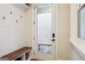 Convenient mud room with built-in bench, storage, and easy access to the outdoors at 114 Village Green Ave, Woodstock, GA 30189