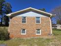 Brick home's gable end with four windows showcasing building's construction at 5447 Ahyoka Dr, Morrow, GA 30260