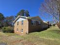 Brick home with side view and covered porch showcasing architectural design at 5447 Ahyoka Dr, Morrow, GA 30260