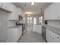 Bright kitchen boasting white cabinetry, stainless steel appliances, and an open layout at 5995 Crowley Dr, Douglasville, GA 30135