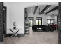 Bright, open-concept living room featuring hardwood floors, beamed ceilings, and modern decor at 4100 Oak Hill Rd, Douglasville, GA 30135