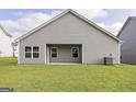 Back exterior view of the home with a well-maintained green lawn at 289 Limestone Circle, Conyers, GA 30013