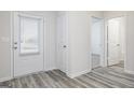 Entryway featuring wood-look flooring, white doors, and natural light at 289 Limestone Circle, Conyers, GA 30013
