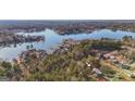 Beautiful aerial shot of the property highlighting its location nestled among trees near a lake, with a small arrow pointing to it at 1068 Little Vine Church Rd, Villa Rica, GA 30180