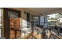 Cozy front porch featuring outdoor seating, a stained front door, and a charming exterior, great for relaxing at 1068 Little Vine Church Rd, Villa Rica, GA 30180