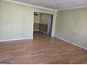 Open living room featuring hardwood floors and neutral color palette at 216 E Richardson St, Oxford, GA 30054