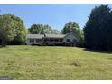 Lovely single-story house with a spacious lawn, complemented by mature trees for added privacy at 6365 Mountain View Trl, Cumming, GA 30041