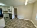 Kitchen area featuring white cabinets and stainless steel appliances at 9184 Thrash Sw St, Covington, GA 30014