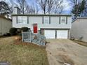 Charming home featuring a two-car garage, gray siding, and well-maintained landscaping at 2232 Ramblewood Ne Cir, Decatur, GA 30035