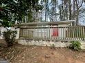 Inviting single-story home with a brick facade and a wood porch in a peaceful, wooded setting at 4352 Glenwood Pkwy, Decatur, GA 30032