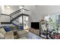 Inviting living room featuring a cozy couch, TV, and staircase to the second floor at 3099 Balearic Se Dr, Marietta, GA 30067