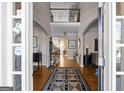 Grand foyer boasts hardwood floors, soaring ceilings, elegant archways, and wrought iron staircase at 1615 Chattahoochee Run Dr, Suwanee, GA 30024