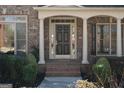 Charming front entrance with brick steps, white columns, and a classic paneled door at 1615 Chattahoochee Run Dr, Suwanee, GA 30024