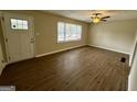 Bright living room featuring new flooring, a modern ceiling fan, and neutral paint at 1908 S Columbia Pl, Decatur, GA 30032
