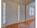 Bright foyer featuring wood floors and a window at 6380 Winston Trce, Mcdonough, GA 30252