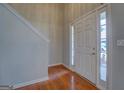 Foyer featuring wood floors at 6380 Winston Trce, Mcdonough, GA 30252