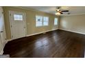 Living room with hardwood floors, ceiling fan, a front door, and ample light at 2194 Loring Ct, Decatur, GA 30032