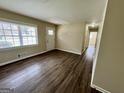 Bright living room featuring new vinyl floors, fresh paint, and natural light at 1145 Penn Se Ct, Atlanta, GA 30315