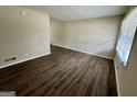 Open living space with vinyl floors, neutral walls, and a view from the entrance at 1145 Penn Se Ct, Atlanta, GA 30315