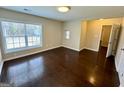 Bright bedroom with hardwood floors and large window with blinds at 5319 Orly Ter, South Fulton, GA 30349