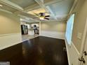 Open-concept living area flows into the kitchen, featuring dark wood floors and beamed ceilings at 230 Argus Cir, Atlanta, GA 30331