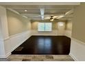 Bright living room with dark wood floors, white wainscoting, and a ceiling fan at 230 Argus Cir, Atlanta, GA 30331