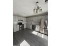 Modern kitchen features stainless steel appliances, white cabinets, granite counters, and new flooring at 4049 Heritage Valley Ct, Norcross, GA 30093