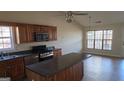 The kitchen features wooden cabinets, stainless steel appliances, and a center island with a dark countertop at 1006 Harbor View Ln, Mcdonough, GA 30252