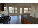 Open-concept kitchen featuring wood cabinets, a gas range, and an island, seamlessly connecting to the dining area at 1006 Harbor View Ln, Mcdonough, GA 30252