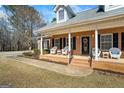 Inviting front porch with white columns, brick accents, and ample seating at 1191 Rawlings Dr, Rutledge, GA 30663