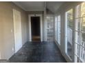 Enclosed porch with stone floors, white trim, and large windows, perfect for enjoying the outdoors year-round at 294 Hascall Nw Rd, Atlanta, GA 30309