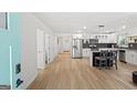 Bright, open kitchen with modern appliances, island seating, and gorgeous wood flooring at 1077 Peeples Sw St, Atlanta, GA 30310