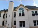Exterior view of a newly constructed home with multiple windows and brick chimney at 2910 Battlecrest Dr, Decatur, GA 30034