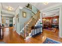 Elegant foyer featuring hardwood floors, staircase, and views of dining and living areas at 707 Orleans Trce, Peachtree City, GA 30269