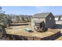 Large fenced backyard featuring a raised deck, patio, and space for outdoor recreation at 157 Donovan Ave, Locust Grove, GA 30248
