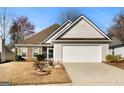 Charming home featuring a two-car garage, small garden, and inviting curb appeal at 1160 Strath Clyde Way, Mcdonough, GA 30253