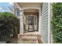 Inviting front entrance with classic architectural details and a brick-paved walkway at 6448 Mobilis Ct, Sugar Hill, GA 30518