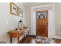 Warm, inviting foyer with hardwood floors and decorative wooden front door at 101 Dean Cir, Mcdonough, GA 30253