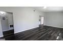 Spacious living room with modern gray walls and newly installed, dark-stained laminate flooring throughout at 4214 Canby Ln, Decatur, GA 30035