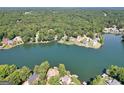 Scenic aerial view of waterfront properties nestled among lush trees and a serene lake at 1283 Heritage Dr, Villa Rica, GA 30180