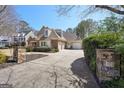 Spacious driveway leading to a charming multi-car garage, surrounded by lush landscaping at 210 Steeple Point Dr, Roswell, GA 30076