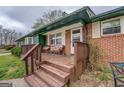 Cozy front porch with wooden steps and a seating area at 10174 Twin Oaks Sw Dr, Covington, GA 30014