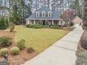 Beautifully landscaped home with mature trees and a long driveway at 2407 Honey Ct, Mcdonough, GA 30252