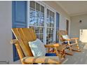 Relaxing front porch area with comfortable rocking chairs and blue accent shutters at 215 Farr Lake Dr, Tyrone, GA 30290