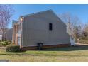 Side view of home showcasing siding, brick foundation, and green lawn at 1942 Grove Way, Hampton, GA 30228